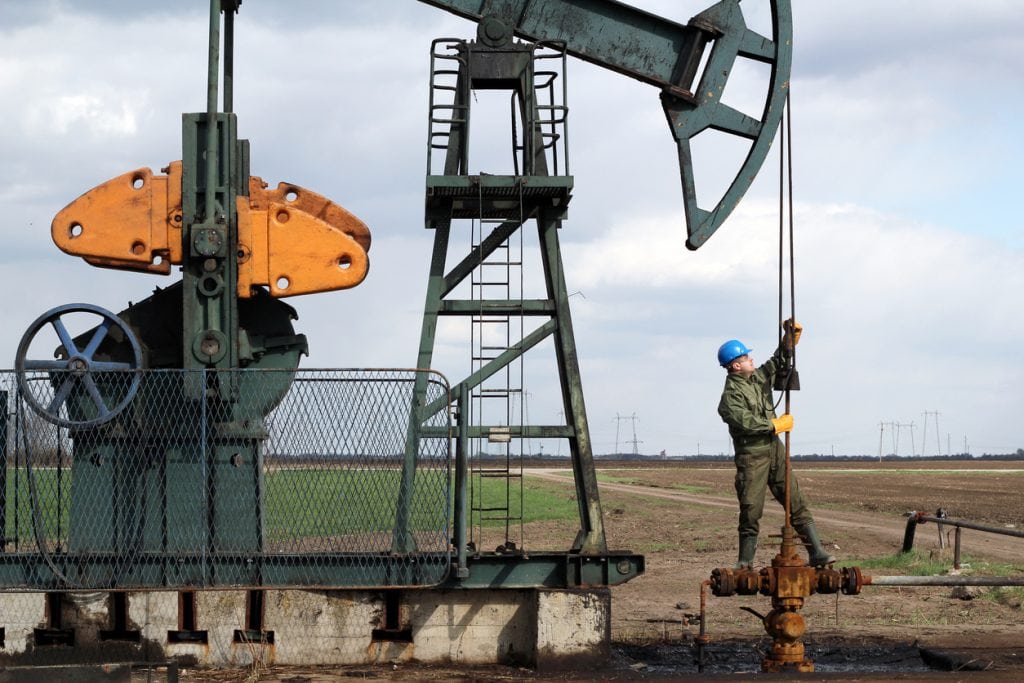 oil worker standing at pipeline Subcontractors USA