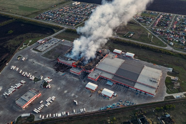 Aerial view of burnt industrial warehouse or logistics center building